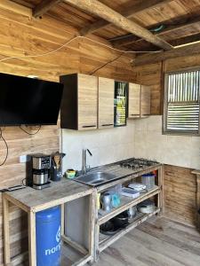 a kitchen with a sink and a stove top oven at Bungalow Palmar del Viento by AMAUNA in Moñitos