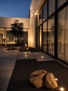 a teddy bear sitting on the ground in front of a building at Hummingbird Dubai in Dubai +23 photos