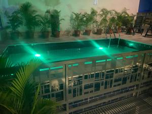 a swimming pool with blue lights on top of a building at Teestone Hotels and Apartment Ikeja in Lagos