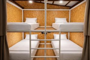 a room with four bunk beds in it at Seaside Dorm Cenang in Pulau Tepur +3 photos