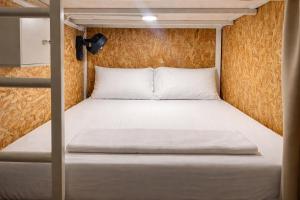 a bed in a small room with a bunk bed at Seaside Dorm Cenang in Pulau Tepur