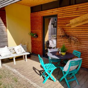 a patio with a table and chairs and a bench at Au petit Mittlach in Mittlach