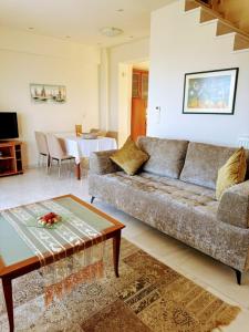 a living room with a couch and a table at Seaside House 2 in Polychrono