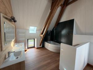 a bathroom with two sinks and a mirror at Gîte Les Jacquets in Hautefort +9 photos