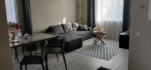 a living room with a couch and a table at Villa by the Baltic Sea in Palanga