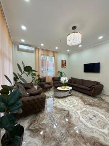 a large living room with couches and a tv at SkyHouse Batumi in Batumi