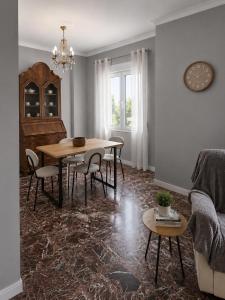 a living room with a table and chairs and a couch at Aggelina's Apartment in Zakynthos +8 photos