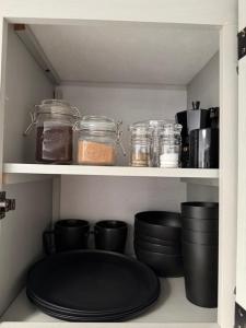 a pantry with jars and dishes on shelves at Sin Ancla in Boqueron +9 photos