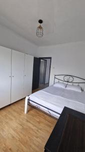 a bedroom with a large bed and a wooden floor at Xilagani Central House in Xilaganí +14 photos