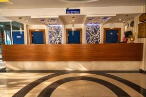 a hospital lobby with blue doors in a building at Kleopatra Micador Otel in Alanya +57 photos