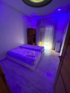 a bedroom with a bed in a purple room at Villa CULUPIA in Kelibia