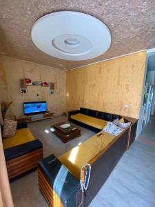a living room with a couch and a large ceiling at Villa CULUPIA in Kelibia +2 photos