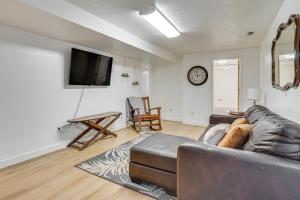 a living room with a couch and a flat screen tv at Utah Valley Basecamp: Apt for Hikers & Explorers! in Spanish Fork