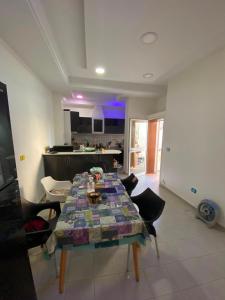 a table in a living room with a kitchen at Villa CULUPIA in Kelibia