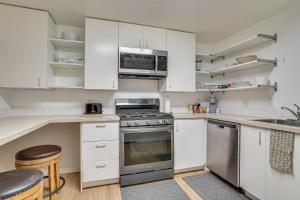 a kitchen with white cabinets and a stove at Utah Valley Basecamp: Apt for Hikers & Explorers! in Spanish Fork +13 photos