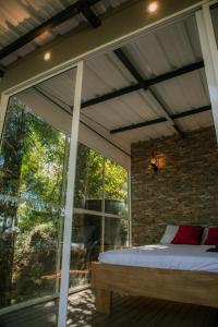 a bedroom with a bed and a large window at Natural Glamping Cocorna in Cocorná +25 photos