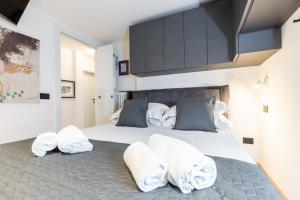 a bedroom with towels sitting on a bed at Aosta Centre Apartments - Santo Stefano in Aosta