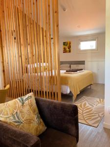 a bedroom with a bed and a couch in a room at Ripado Loft in Ponta Delgada