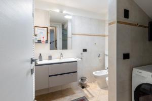 a bathroom with a sink and a toilet at Aosta Centre Apartments - Santo Stefano in Aosta