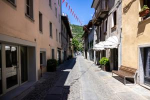 an empty street with a bench in an alley at Aosta Centre Apartments - Santo Stefano in Aosta