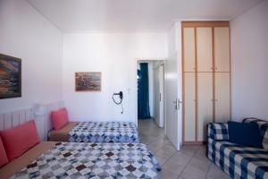 a bedroom with a bed and a couch at Hara's Studio in Perdika