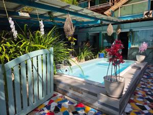 a swimming pool with plants and a fence at Monkey beach agroturismo in Gamboa