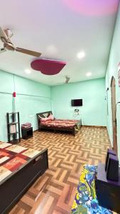 a living room with a couch and a flat screen tv at Gravity Groups Core - La Maison Villa in Pondicherry +15 photos