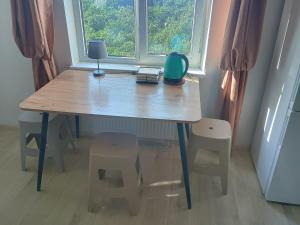 a table and stools in a room with a window at Уютная комната в квартире в ЖК Одесский Бульвар in Teremki