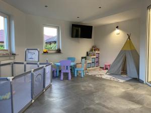 a living room with a table and a tent at Laguna Blue in Grzybowo
