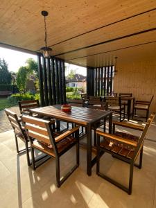 a wooden table and chairs on a patio at Laguna Blue in Grzybowo