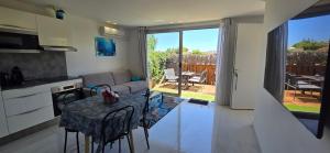 a kitchen and a living room with a table and a couch at Villa HARMONY in Vallauris