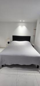 a bedroom with a white bed with a black headboard at Villa HARMONY in Vallauris +63 photos