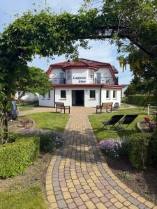 a building with a brick walkway in front of it at Laguna Blue in Grzybowo