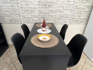 a black table with a plate and a drink on it at Downtown Hub 1 in Alexandroupoli
