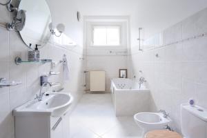 a white bathroom with two sinks and a tub and a toilet at Zámeček Rozkoš in Střížovice +47 photos