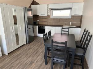 a kitchen and dining room with a table and chairs at ZR9 in Zamárdi