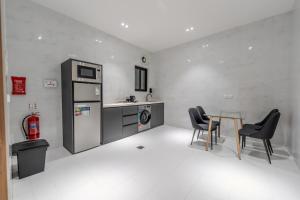 a kitchen with a table and chairs in a room at wend house in Jeddah