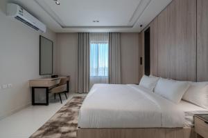 a hotel room with a bed and a desk at wend house in Jeddah