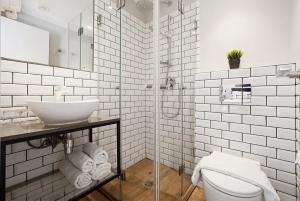a white bathroom with a sink and a toilet at City Port Hotel by Sea N Rent in Haifa +77 photos