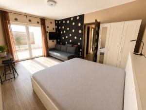 a bedroom with a bed and a couch in it at ZR9 in Zamárdi
