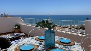 a table with a vase on top of a balcony at BLUE OASIS Mojácar in Mojácar