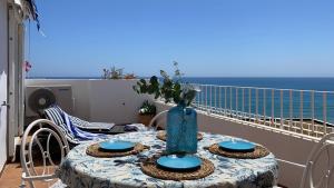 a table with a blue vase on top of a balcony at BLUE OASIS Mojácar in Mojácar