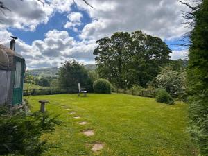 a park with a bench in the middle of a yard at Sunbank Yurt in Llangollen