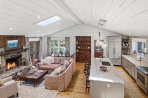 a living room with a couch and a fireplace at Sunset Nest in Highlands
