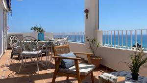 a balcony with a table and chairs and the ocean at BLUE OASIS Mojácar in Mojácar +29 photos