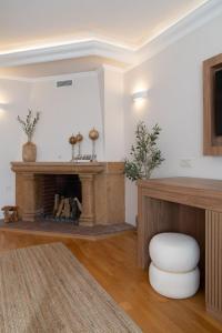 a living room with a fireplace and a stool at OLEO hotel in Momchilgrad +49 photos