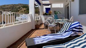 a patio with a table and chairs on a balcony at BLUE OASIS Mojácar in Mojácar