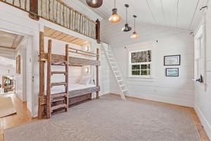 a room with a bunk bed and a ladder at Sunset Nest in Highlands