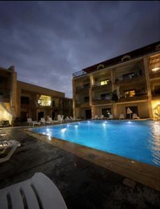 a large swimming pool in front of a building at chalet in saint remon in Al ‘Ayn