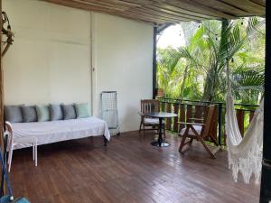 a living room with a couch and a table at Nahele Lodge in Santa Teresa Beach